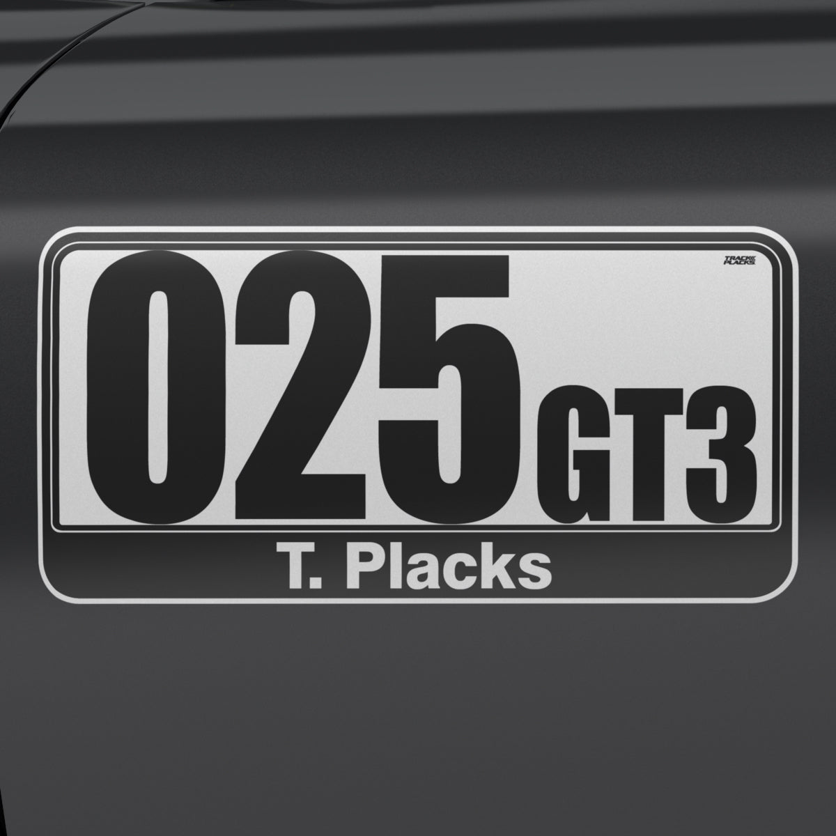025 GT3, black on white, T. Placks footer TrackPlacks CLUB Basic regulation race number plate – black on white, number 025, class GT3, custom footer T. Placks, applied to car door